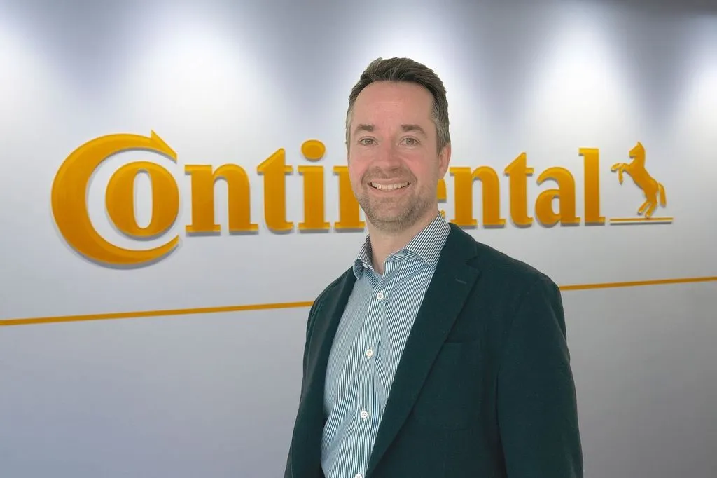 Grant Willman stood in front of the Continental logo
