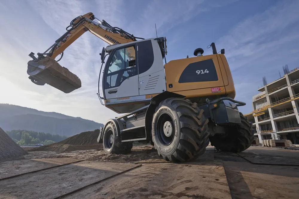 Image of a digger in yellow with Apollo tyres fitted from a low angle
