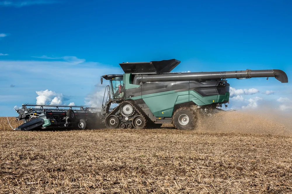 Image of a combine harvestor from the side working in a field