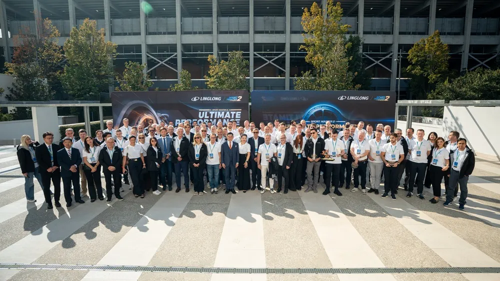 Image of Linglong Tire representatives and suppliers stood in a semi-circle for a photo.